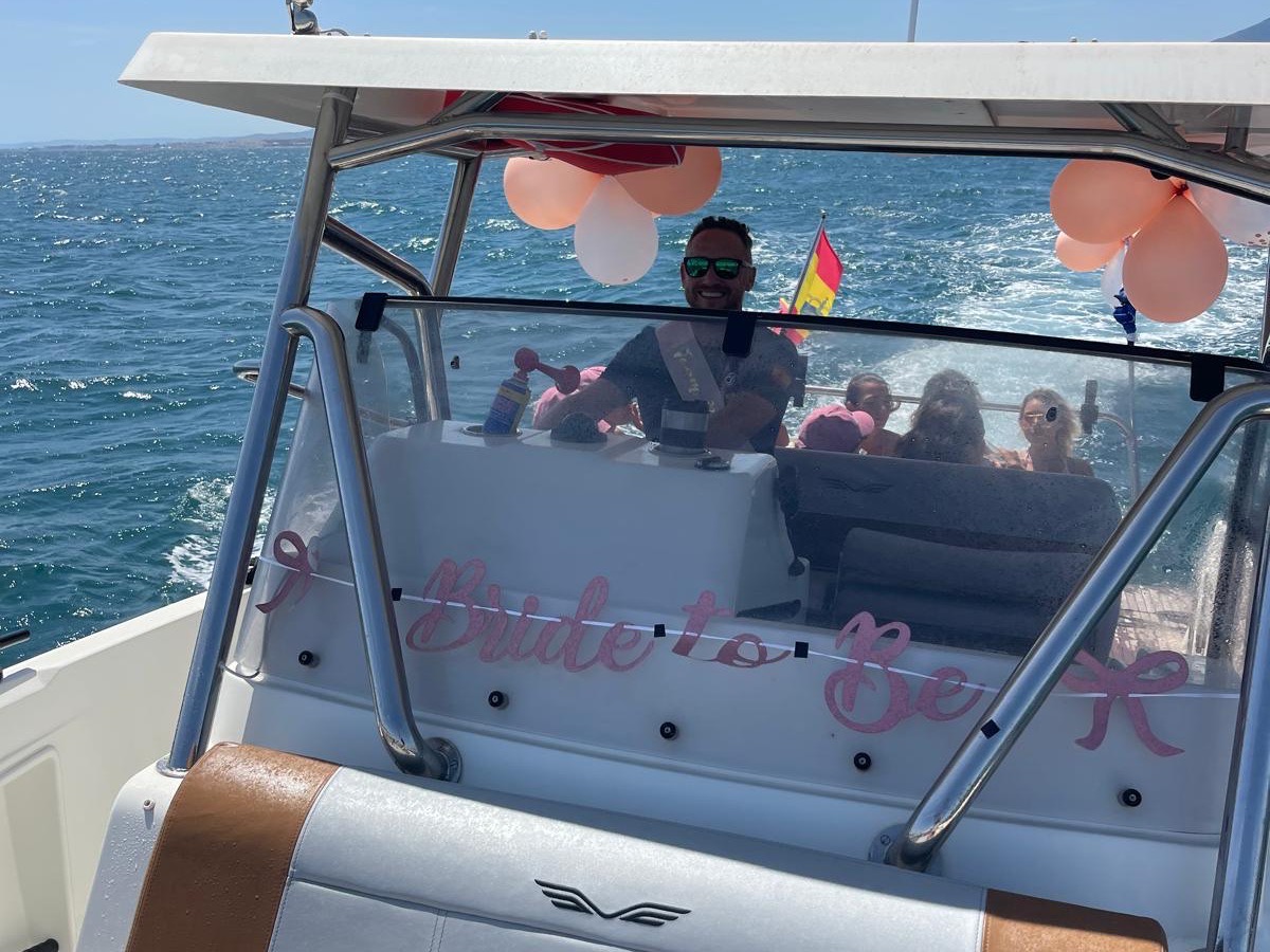 Hen party on board private boat charter in Marbella with Bride to Be banner and balloons